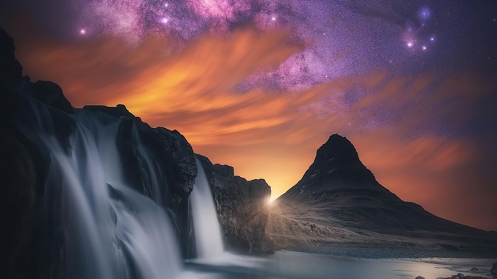 Waterfall and mountain under starry sky