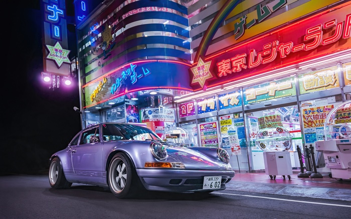 Purple Porsche 911 in front of Tokyo arcade at night