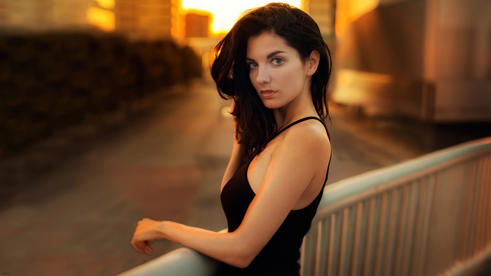 Woman in black dress at sunset