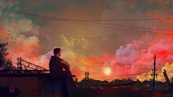 Man sitting on a rooftop at sunset