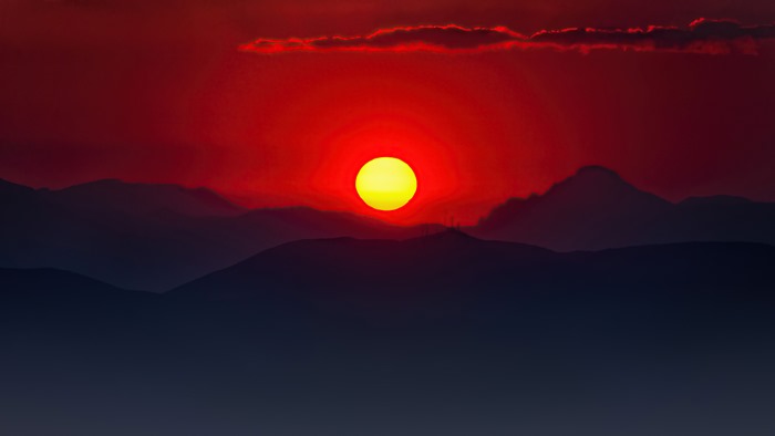 Sunset over mountains with red sky