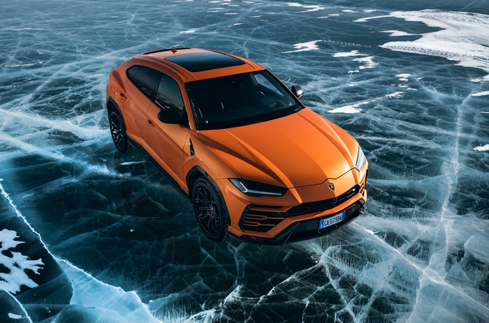 Orange Lamborghini Urus on cracked ice