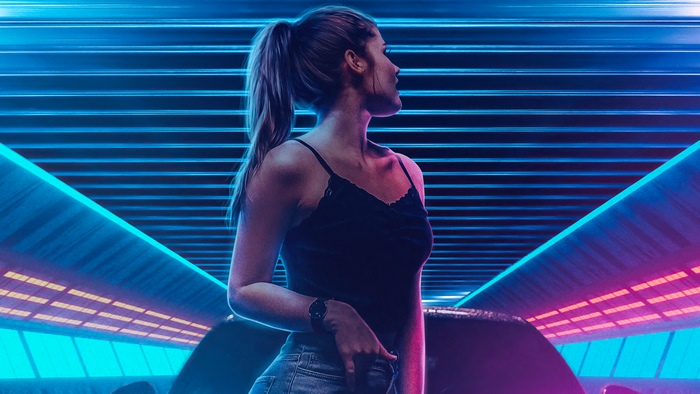 Woman in black tank top under neon lights
