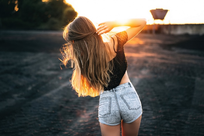 Girl in denim shorts at sunset