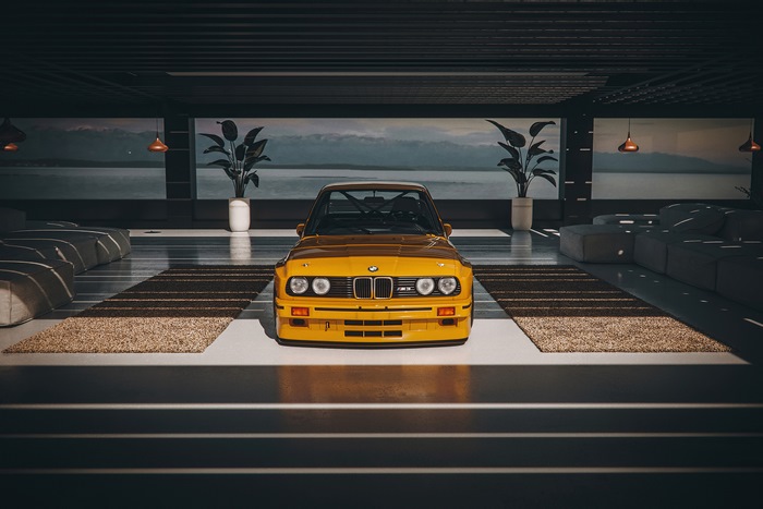 Yellow BMW E30 M3 in modern interior