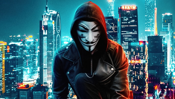 Anonymous masked figure in a city at night