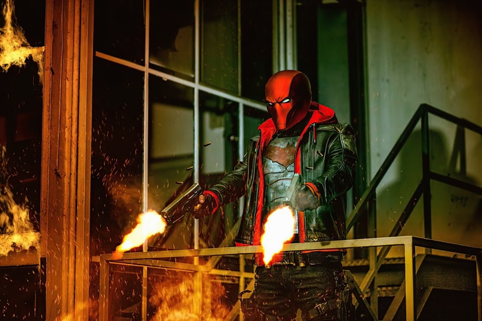 Red Hood firing guns with flames