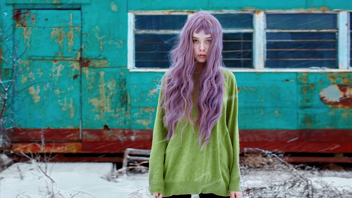 Girl with purple hair in a green sweater