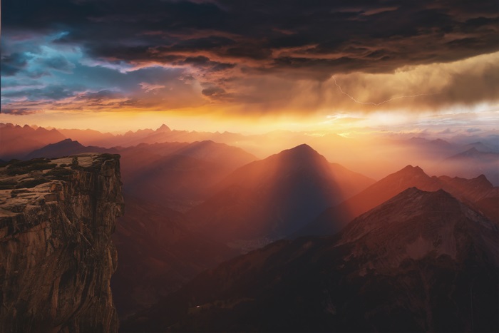 Mountains at sunset with lightning storm