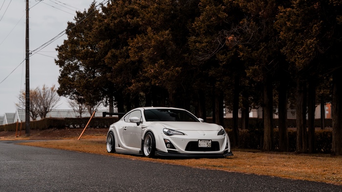 White Toyota GT86 with spoiler on road