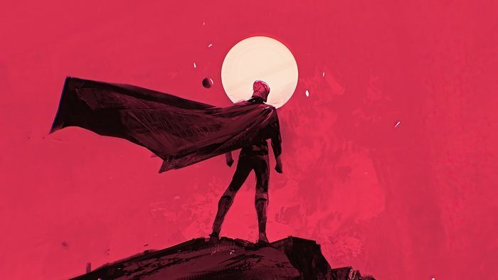Man in cape standing on rock with large moon behind
