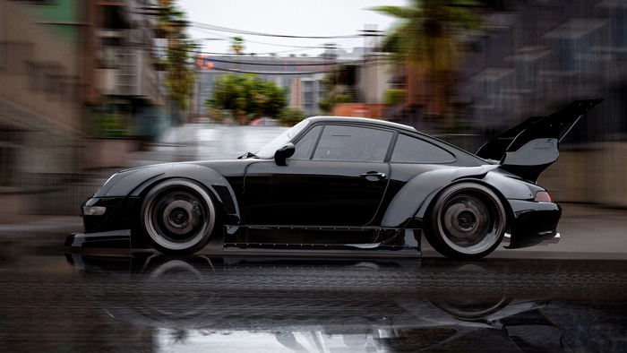 Black Porsche 911 Turbo widebody with a large rear wing