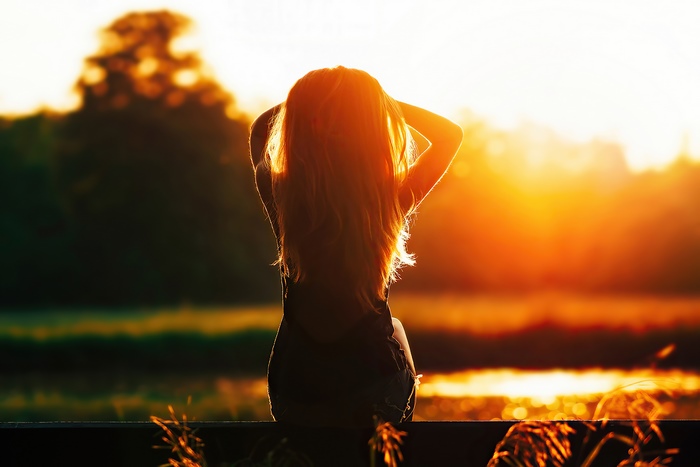 Girl in silhouette at sunset