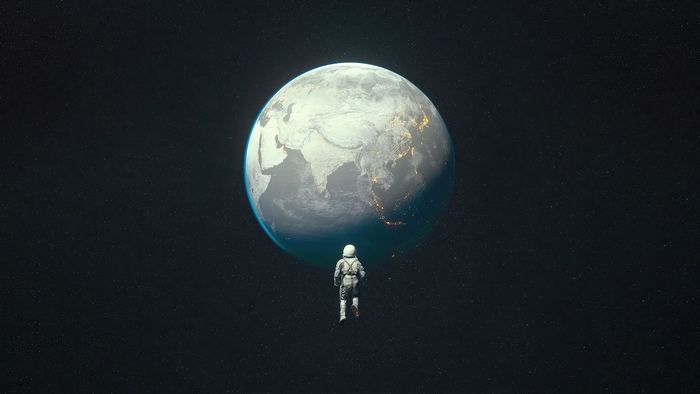 Astronaut floating in space near Earth