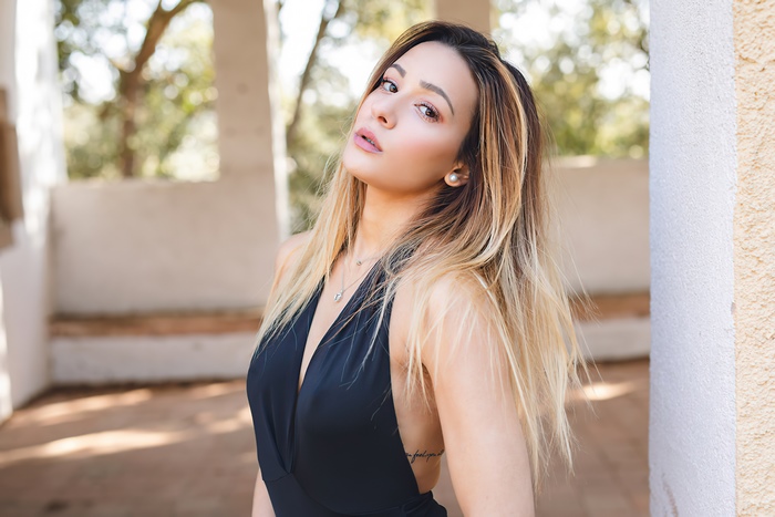 Woman with blonde hair wearing a black dress