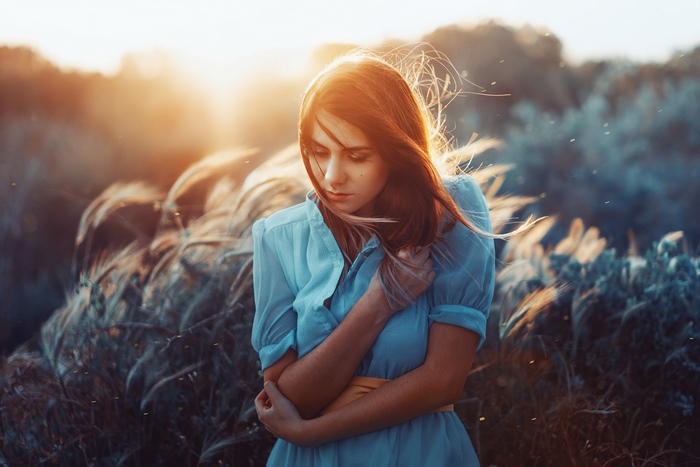 Redhead girl in blue dress in field at sunset 4K