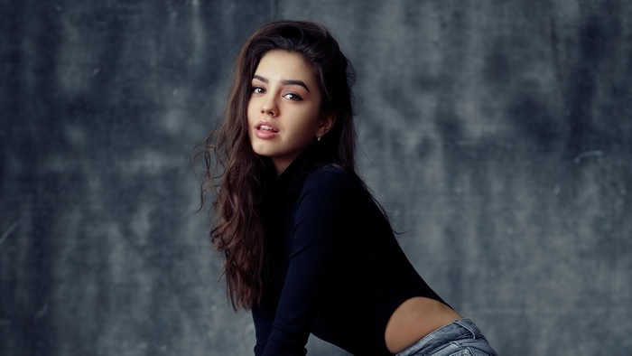 Model in black turtleneck and jeans