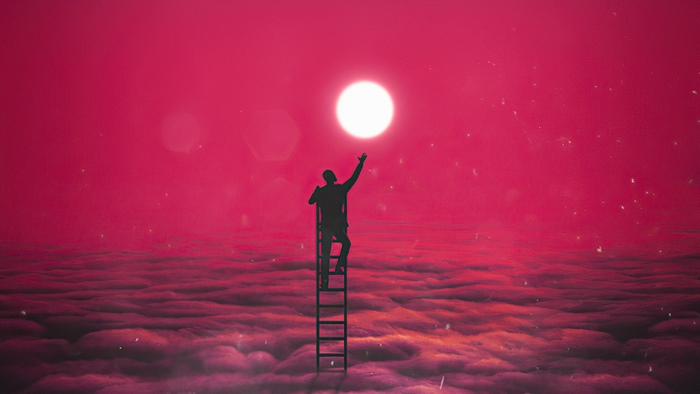 Silhouette of a person on a ladder reaching for the moon