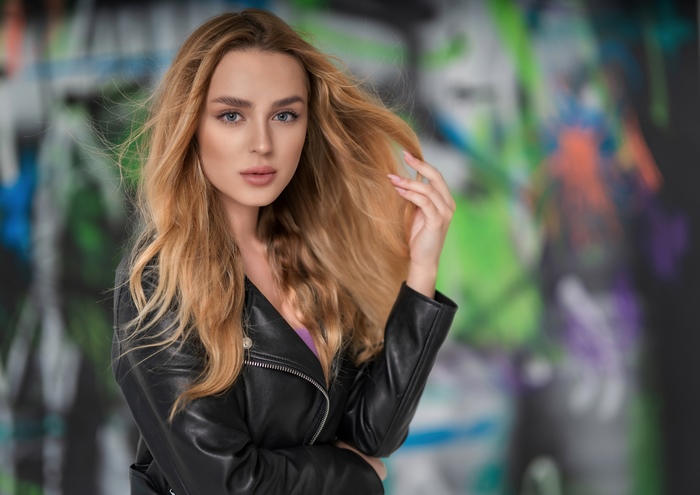 Blonde woman in leather jacket