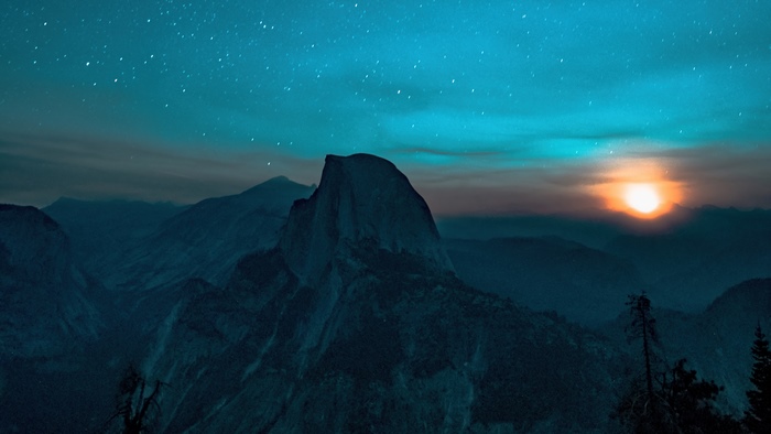 Half Dome mountain under starry sky at sunset