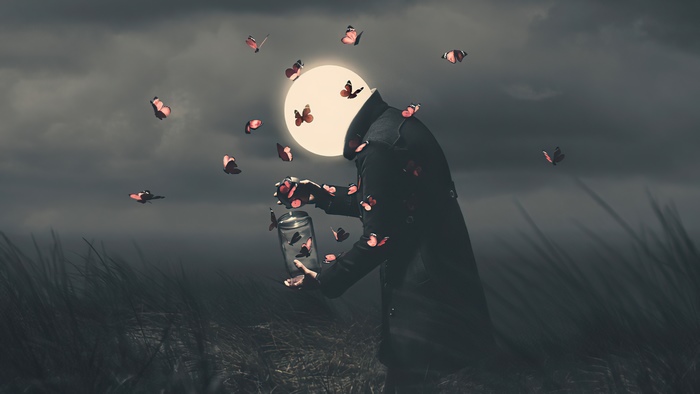 Man with glowing head releasing butterflies from jar