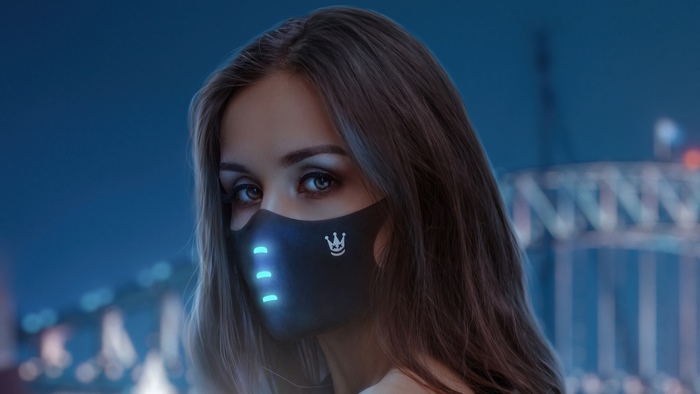 Woman wearing a futuristic mask at night