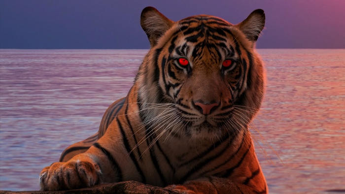 Tiger with glowing red eyes by the ocean at sunset