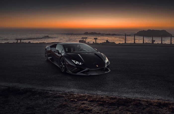 Black Lamborghini Huracan Evo on Coastal Road at Sunset