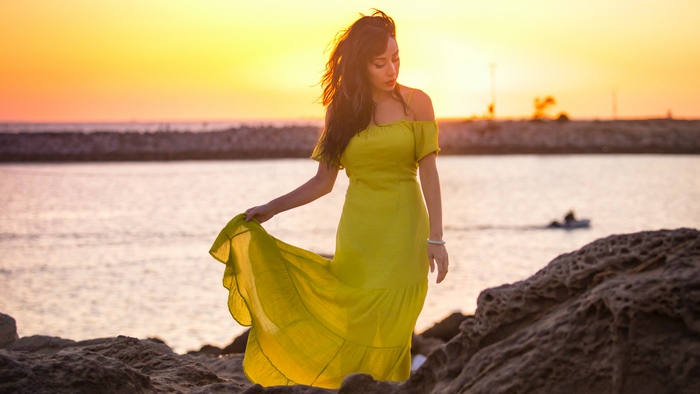 Woman in yellow dress at sunset