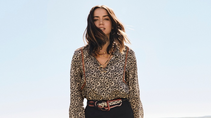 Ana de Armas in a floral shirt and black pants
