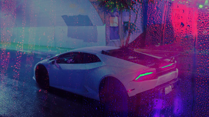 White Lamborghini on wet street at night
