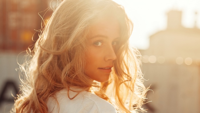 Woman with blonde hair in sunlight