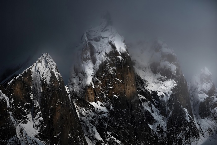 Snow covered mountains in dramatic lighting 4K