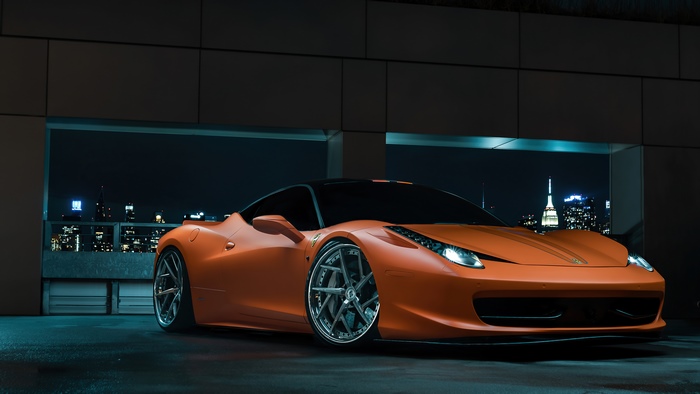 Orange Ferrari 458 Italia parked at night