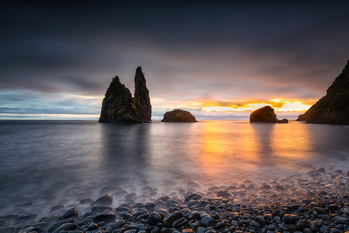 Rocky beach at sunset with sea stacks