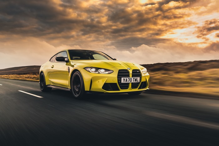 Yellow BMW M4 Coupe on a Road