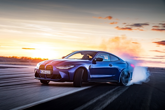 Blue BMW M4 Drifting at Sunset