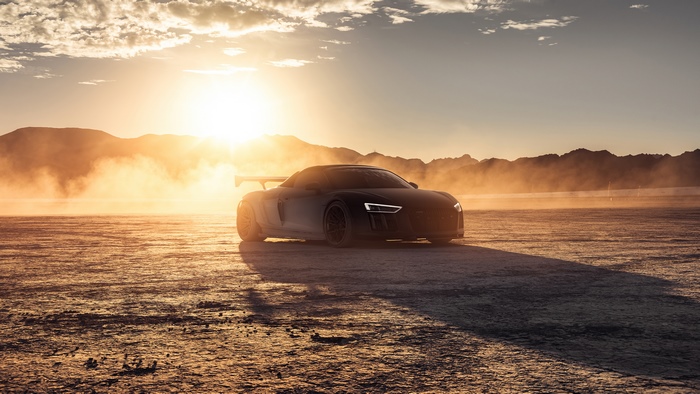 Audi R8 sports car in desert at sunset