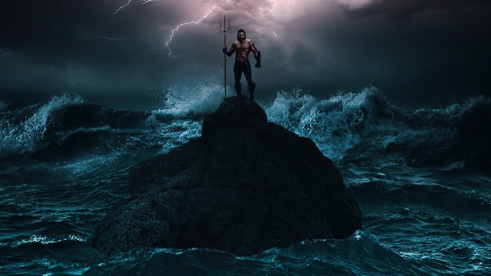 Aquaman standing on a rock in the ocean during a storm