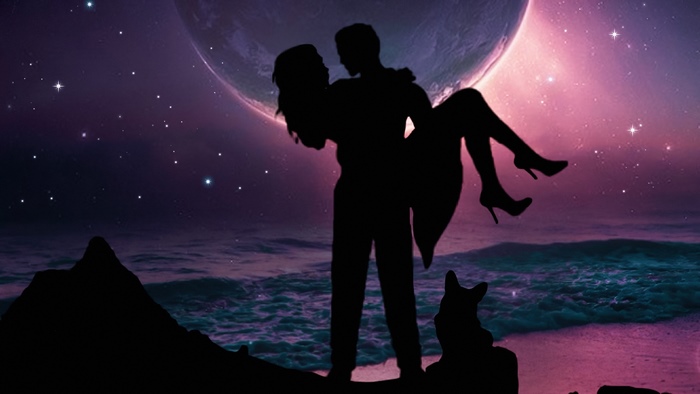 Couple silhouetted against a large moon and starry sky