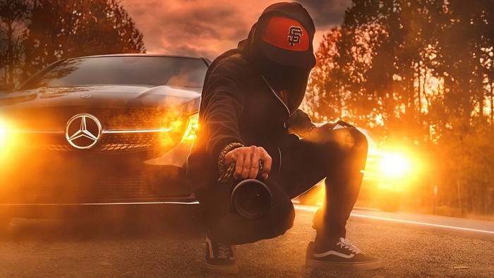 Man with camera and Mercedes-Benz car at sunset