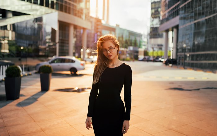 Woman in black dress in city