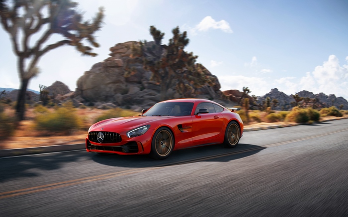 Red Mercedes-AMG GT R driving on a desert road
