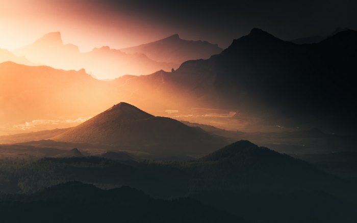 Mountains at sunrise with orange sky