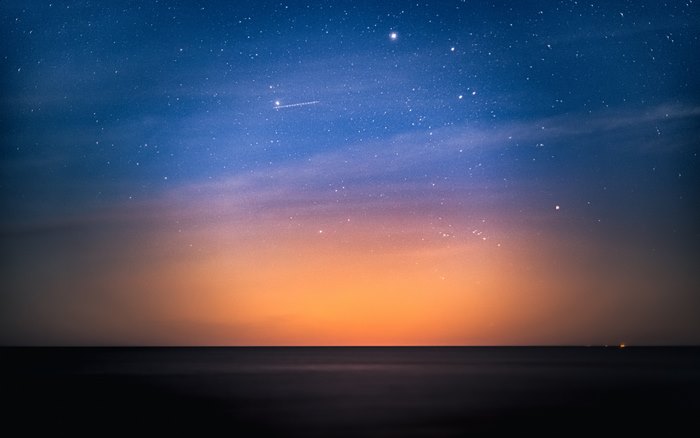 Stars over the ocean at dusk