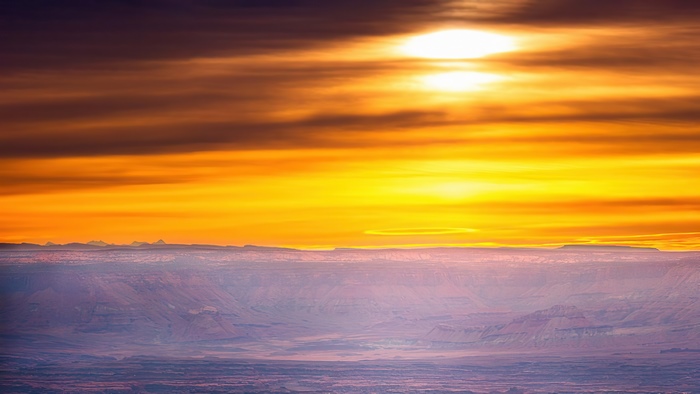 Sunset over a vast canyon landscape