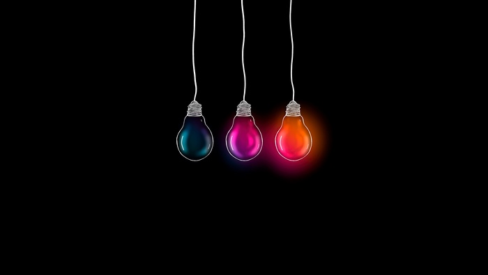 Three colorful light bulbs on black background