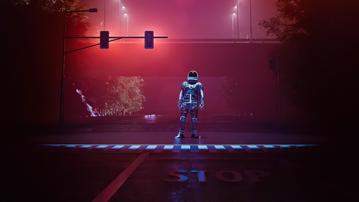 Astronaut standing at a foggy intersection at night