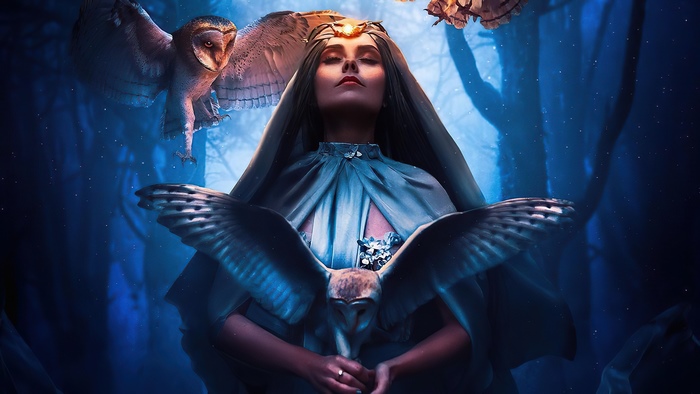 Woman with owls in a forest