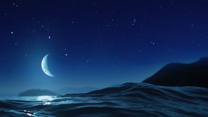 Crescent Moon over a Starry Night Ocean